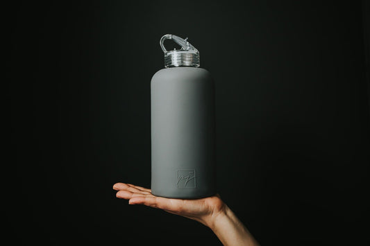 One litre glass water bottle with grey protective silicone sleeve and clear folding straw lid - lifewithPandJ